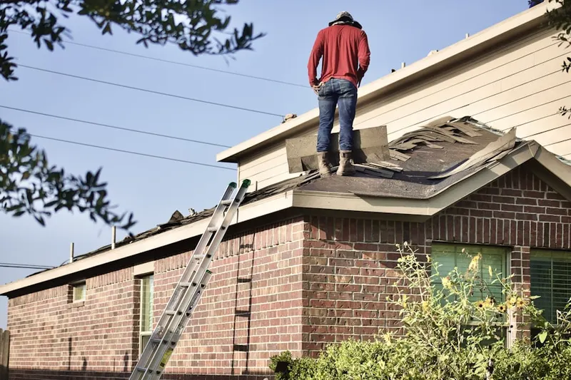 Professional roofer working on a residential roof in Woodlawn Manor